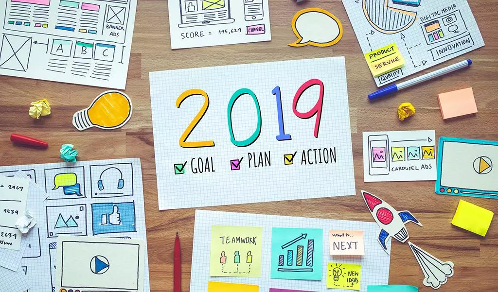 2019 new year resolutions with business digital marketing and paperwork sketch on wood table.analysis strategy concepts ideas