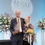 Bobbi Ecker-Blatchford’s children, Bruce and Cyndi, accept her Hall of Fame Award on her behalf during SAF Palm Springs 2018.