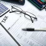 stock image tax form, glasses and a pen