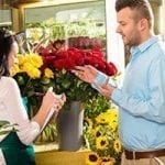 stock image of husband purchasing valentine's day flowers at a florists