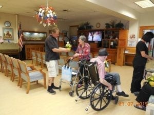 Dave Smith, a driver for Allan's Flowers & More in Prescott, Arizona, delivered Make Someone Smile designs to the Arizona Pioneer's Retirement Home last year.