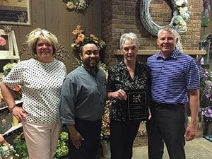 Mary Ann Kutnick (second from right) of Schaefer Greenhouses Inc. in Montgomery, Illinois, receives an FTD 75-year anniversary recognition plaque from (left to right) FTD Regional Vice President Wendy McGoff, FTD Field Business Consultant Edgar DeLaGarza and FTD Florist EVP Tom Moeller.