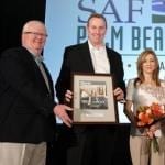 Brad Denham, Cherl Denham receiving the Marketer of the Year Award from Dwight Larimar.