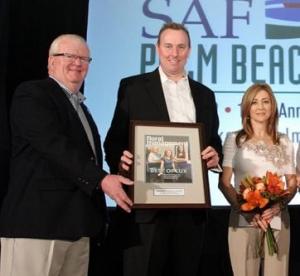 Brad Denham, Cherl Denham receiving the Marketer of the Year Award from Dwight Larimar.