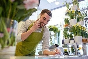 Man takes flower order on the phone