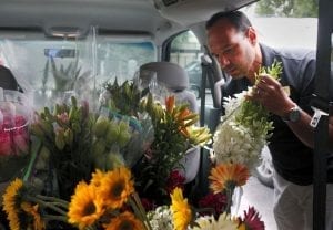Manny Gonzalez of Tiger Lily Florist in Charleston, SC loads flowers into a truck for a Petal It Forward event in October, 2017.