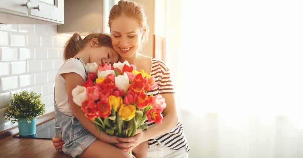 stock image of a mom receiving flowers