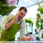 stock image of a man on a phone in a flower