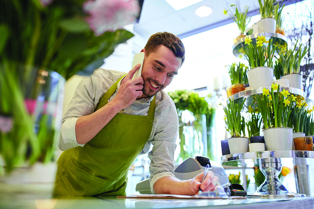 stock image of a man on a phone in a flower