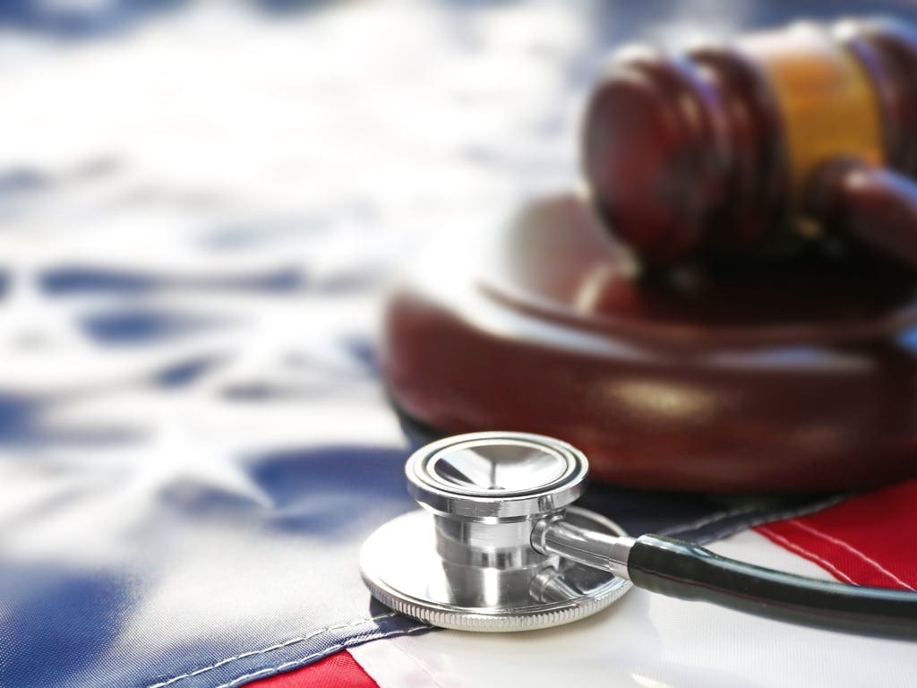 US flag with a stethoscope and a gavel