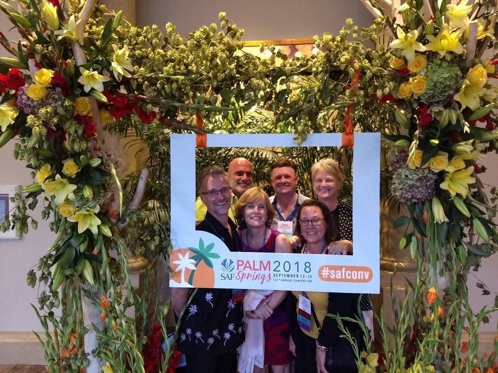 Jenny Behlings, AAF, AIFD, PFCI, SDCF, (upper right) was one of more than 450 floral industry members who participated in SAF Palm Springs 2018 in September, and then returned home with actionable ideas. Pictured with Behlings from left: J. Robbin Yelverton, AAF, AIFD, PFCI, of Blumz by...JRDesigns in metro Detroit, Michigan; Marlin Hargrove, AAF, AIFD, PFCI, of the Pete Garcia Company in Atlanta, Georgia; Theresa Colucci, AAF, AIFD, PFCI, of Meadowscent in Gardiner, New York; D Damon Samuel, AAF, AIFD, PFCI, NAFD, NMF, of the Bill Doran Co. in Omaha, Nebraska; and Julie Poeltler, AIFD, CAFA, PFCI, of Fountain of Flowers & Gifts in Lone Tree, Iowa.