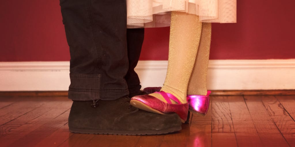 daughter dancing on father's feet