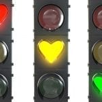 et of traffic light with heart shaped red, yellow and green lamps isolated on white background