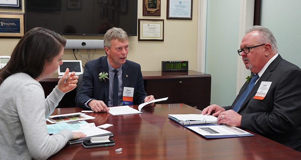 SAF Chairman Martin Meskers (center) of Orgeon Flowers in Aurora, Oregon, and Scott Isensee of Frank Adams Wholesale in Portland, meet in the office of Sen. Jeff Merkely (D-Oregon) during CAD.